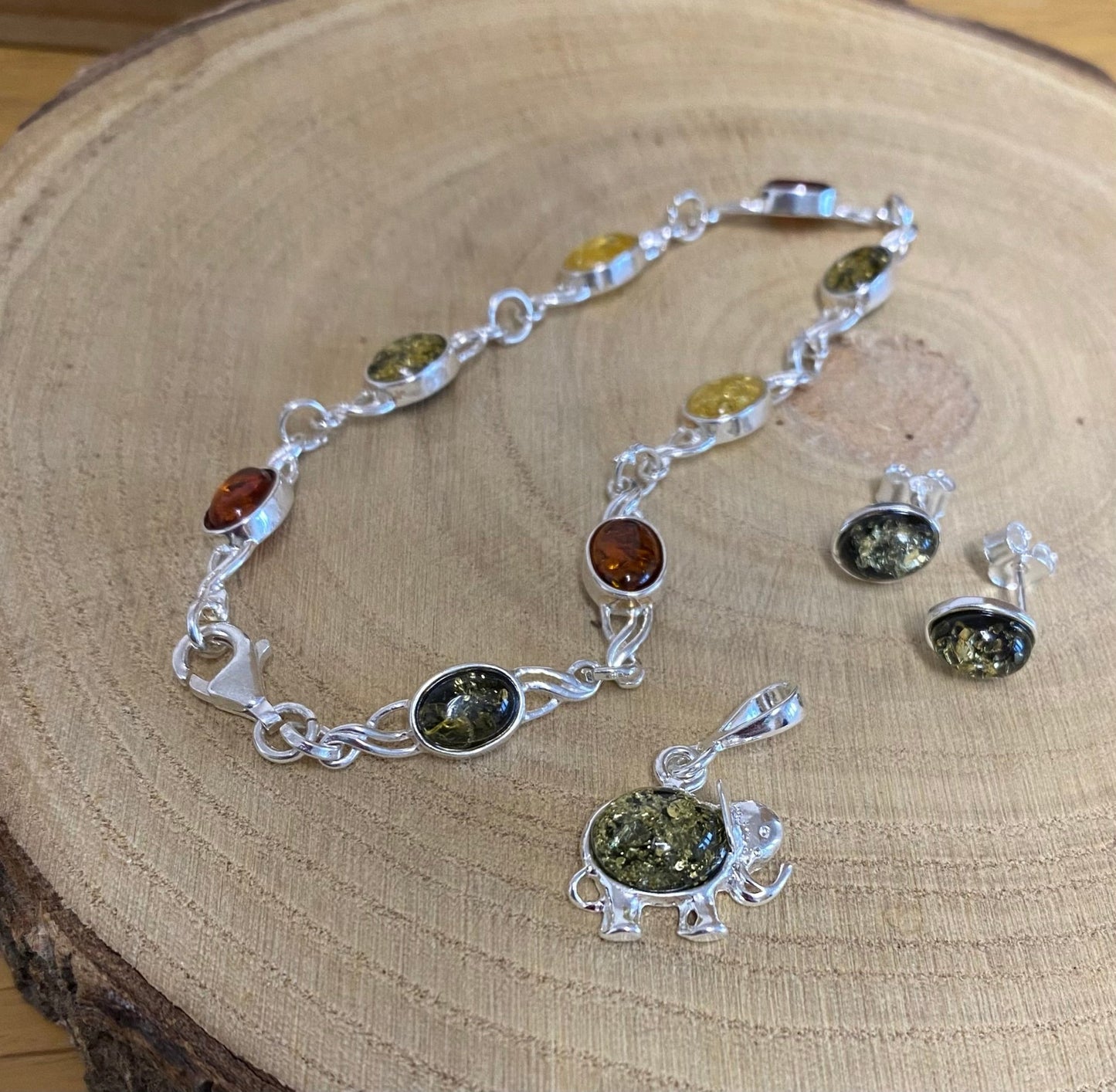 Green Baltic amber lucky elephant charm pendant in sterling silver with matching earrings and necklace