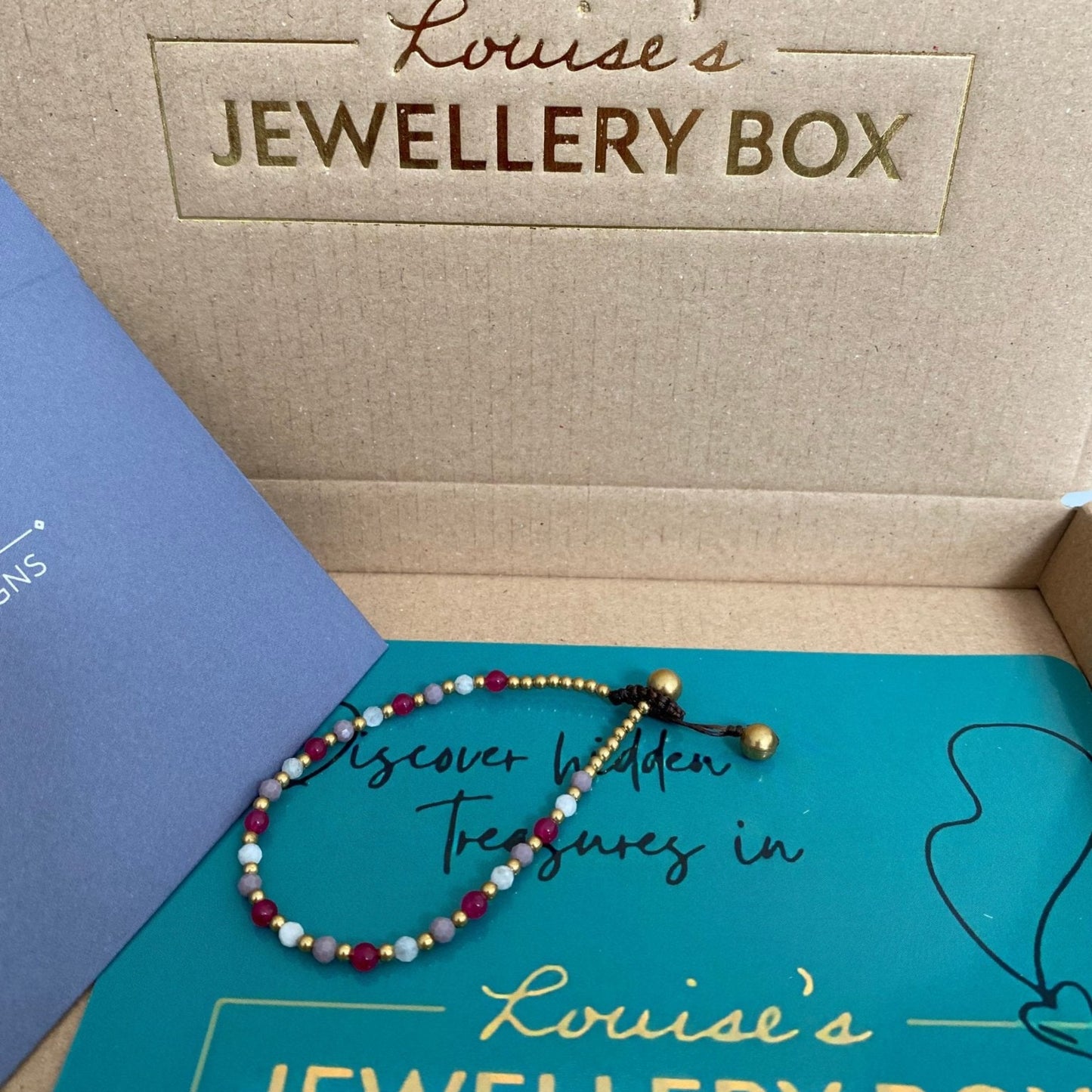 Beaded moonstone crystal healing bracelet for stress resting in the postal box.