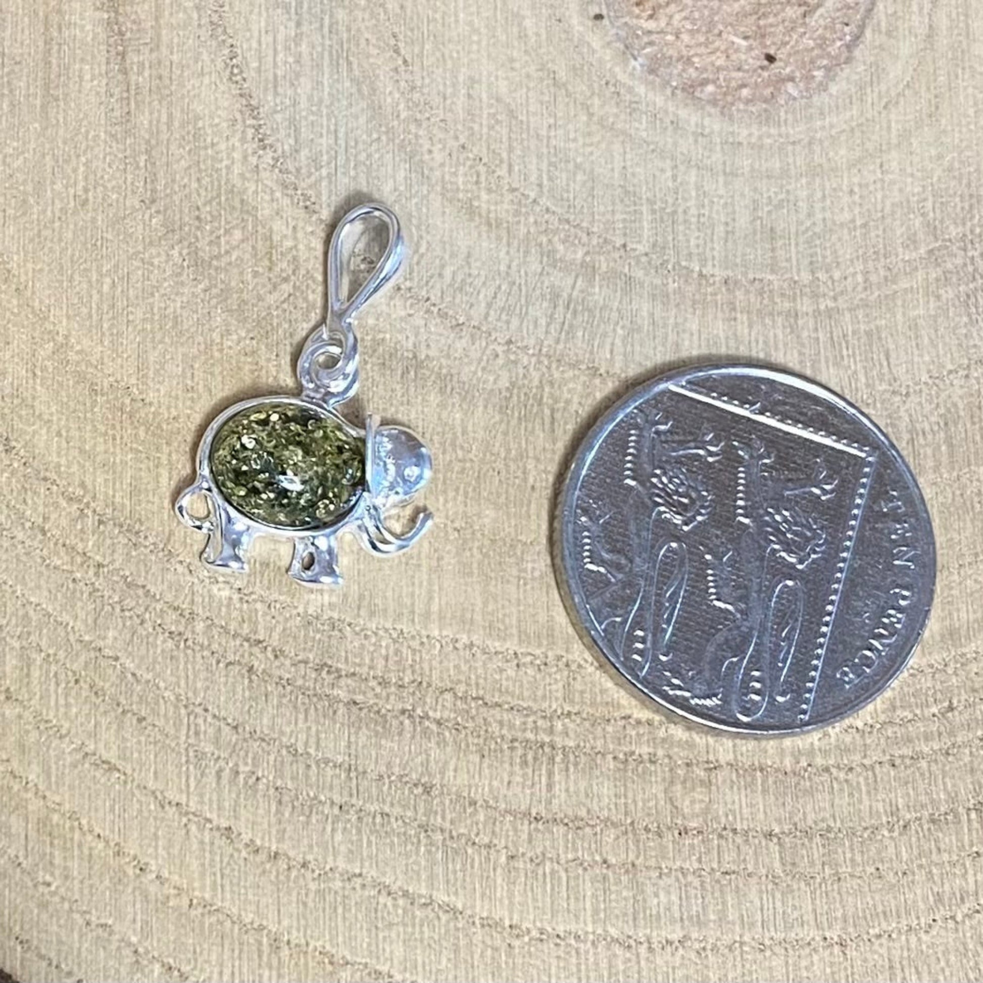 Lucky elephant pendant with raised trunk in 925 sterling silver and green amber

