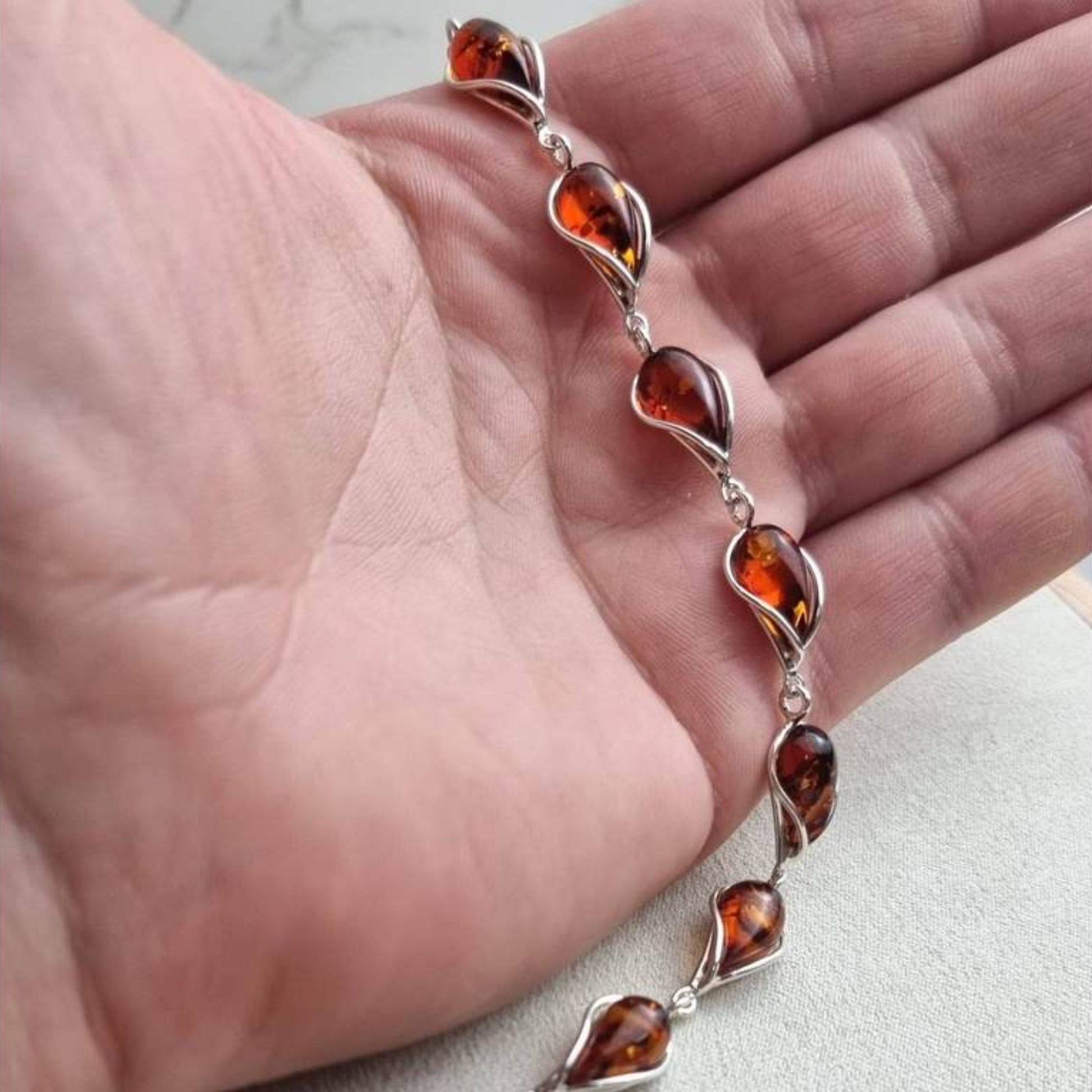 Cognac Baltic amber bracelet in sterling silver with twisted silver frames surrounding each amber stone.