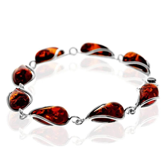 Cognac baltic amber bracelet in sterling silver with glossy finish and teardrop shaped gemstones.