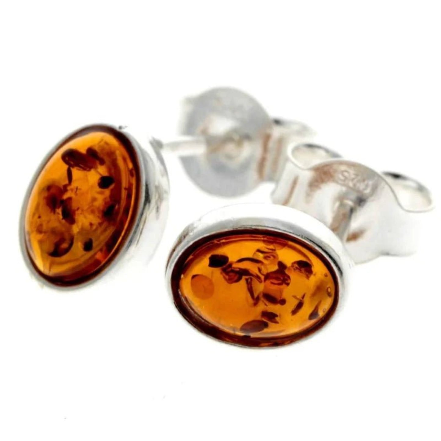 Oval stud earrings in sterling silver and cognac Baltic amber with an inclusions pattern.